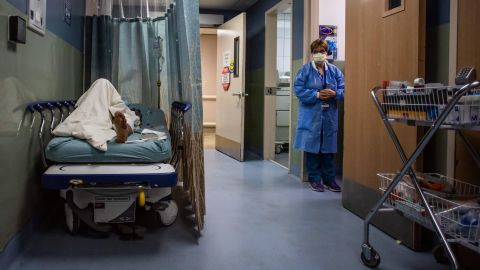 A patient rests in a corridor, waiting for a room at Providence Cedars-Sinai Tarzana Medical Center, a hospital in Tarzana, California, on January 3.