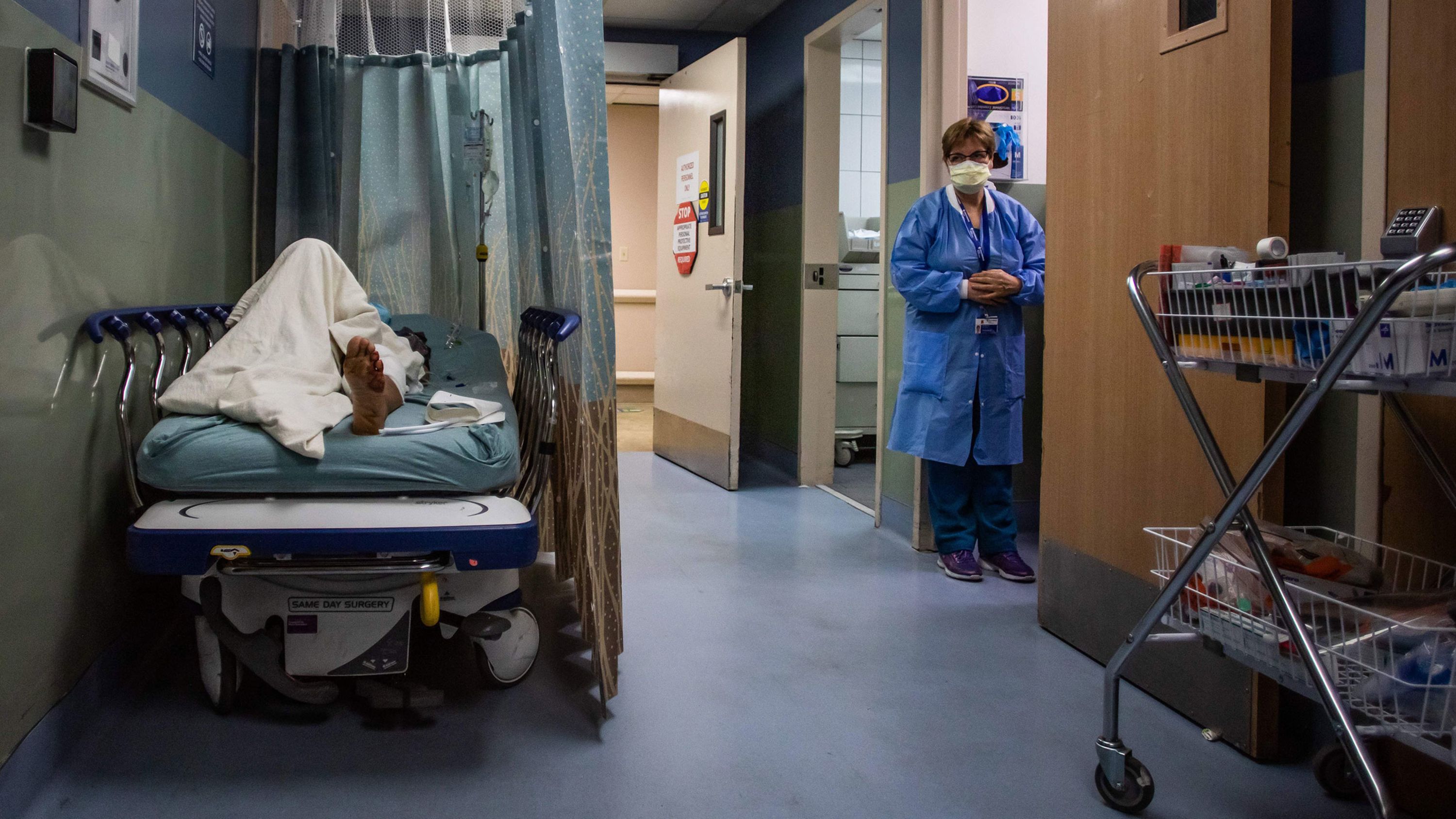 A patient rests in a corridor, waiting for a room at Providence Cedars-Sinai Tarzana Medical Center, a hospital in Tarzana, California, on January 3.