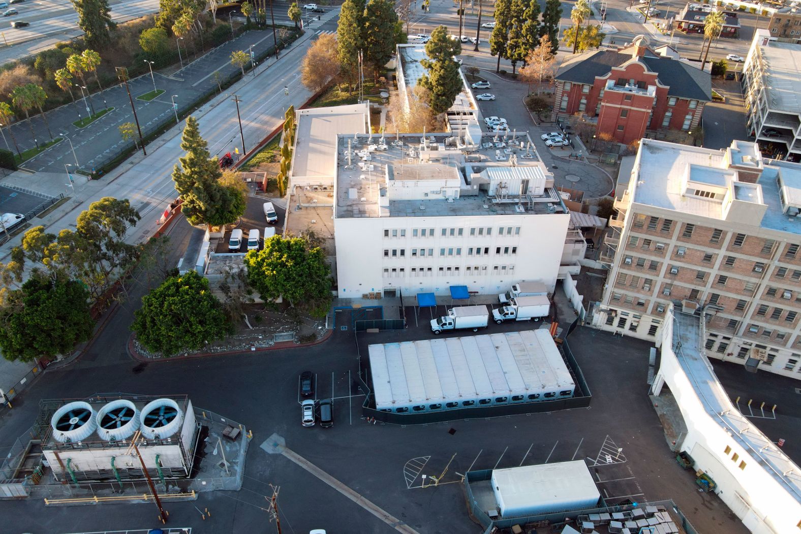 Refrigerated trailers are parked outside the office of the Los Angeles County coroner on January 10. They are acting as temporary morgues.