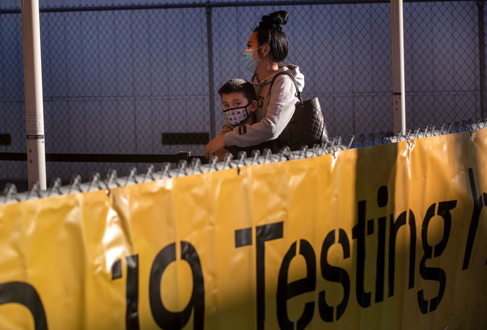 Hawaii-bound travelers Vanna Truong and her 6-year-old son, Frey Das, wait in line for a Covid-19 test in Los Angeles on December 31. A lab is located across Terminal 6 at Los Angeles International Airport, allowing Covid-19 tests to be administered and processed with results in three to five hours.