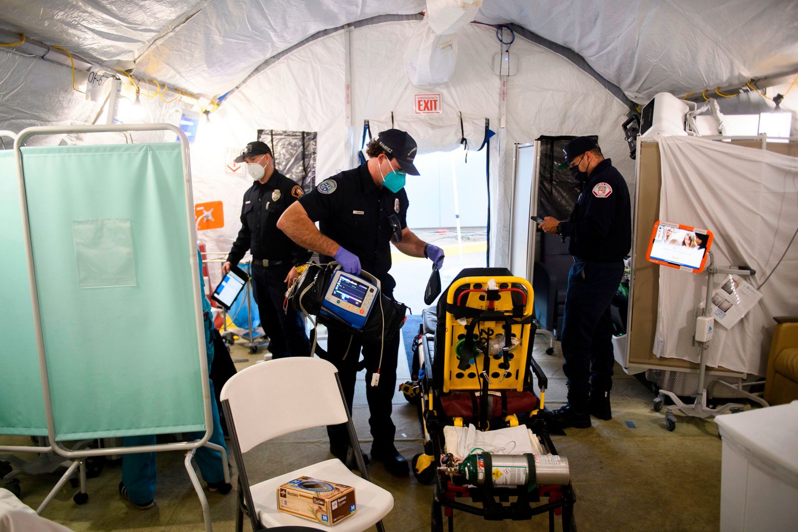 An emergency medical technician packs up equipment after transferring a suspected Covid-19 patient to a field hospital tent outside the emergency department of the Martin Luther King Jr. Community Hospital in Los Angeles on January 6.