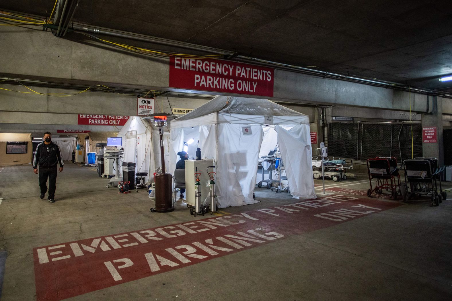 Dr. Thomas Yadegar walks inside a temporary emergency room that was built inside a parking garage at Providence Cedars-Sinai Tarzana Medical Center, a hospital in Tarzana, California.