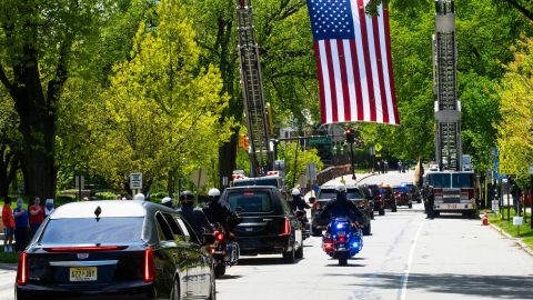 An American flag hangs over the funeral procession of Glen Ridge Police Officer Charles Roberts in New Jersey on May 14, 2020. Roberts was the first officer on the force to die of Covid-19.