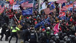 Trump supporters clash with police and security forces as they push barricades to storm the US Capitol in Washington D.C on January 6, 2021.
