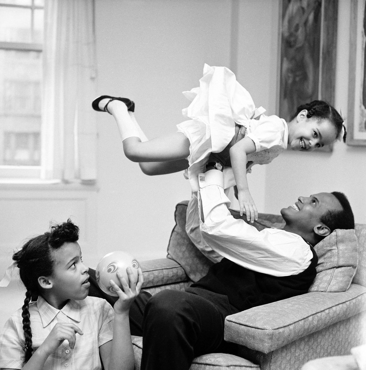Belafonte plays with his daughters Adrienne, left, and Shari in 1959.