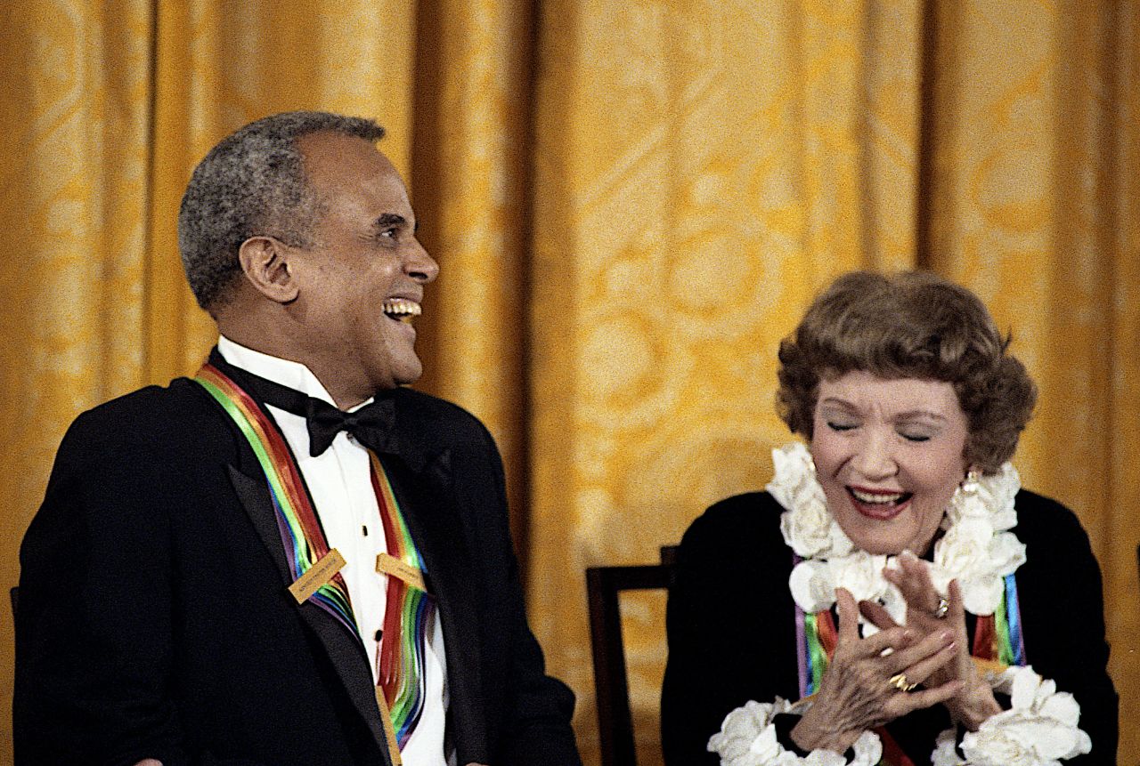 Belafonte and actress Claudette Colbert, two Kennedy Center honorees, laugh at a joke made by first lady Barbara Bush during a reception in Washington, DC, in 1989.