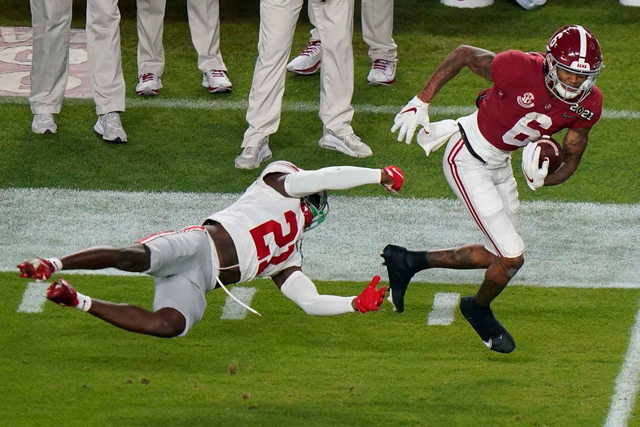 Alabama wide receiver DeVonta Smith slips past Ohio State cornerback Marcus Williamson during the first half. Smith, this year's Heisman Trophy winner, finished the first half with 12 catches, 215 yards and three touchdowns as the Crimson Tide held a 35-17 lead.