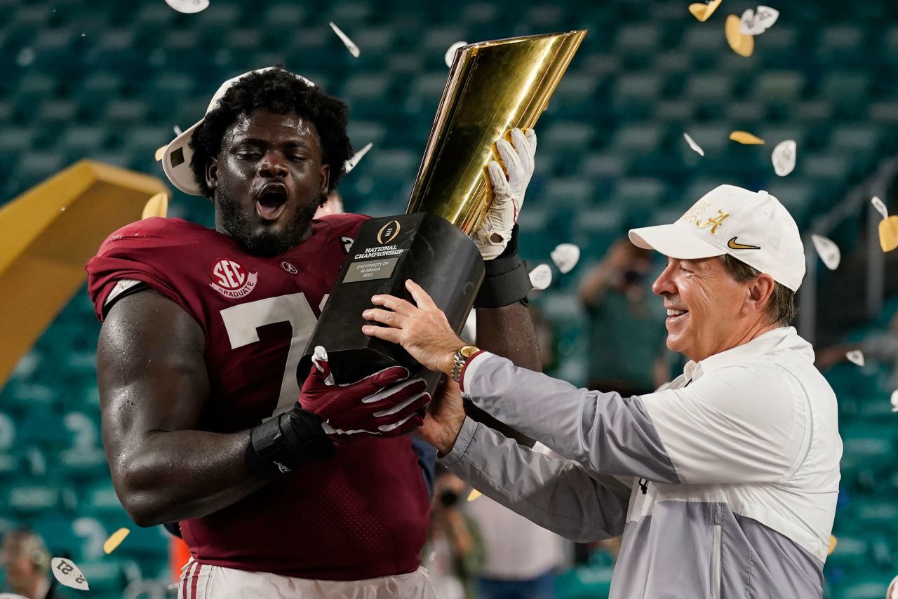 Alabama head coach Nick Saban and offensive lineman Alex Leatherwood hold the trophy after the <a href="https://www.cnn.com/2021/01/11/sport/gallery/college-football-championship-alabama-ohio-state-photos/index.html" target="_blank">Crimson Tide defeated Ohio State</a> to win the national title on Monday, January 11, in Miami Gardens, Florida. Alabama won 52-24.