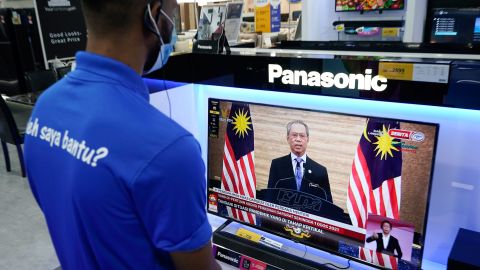 An electronic shop worker watches a live broadcast of Malaysian Prime Minister Muhyiddin Yassin in Kuala Lumpur, Malaysia on January 12.