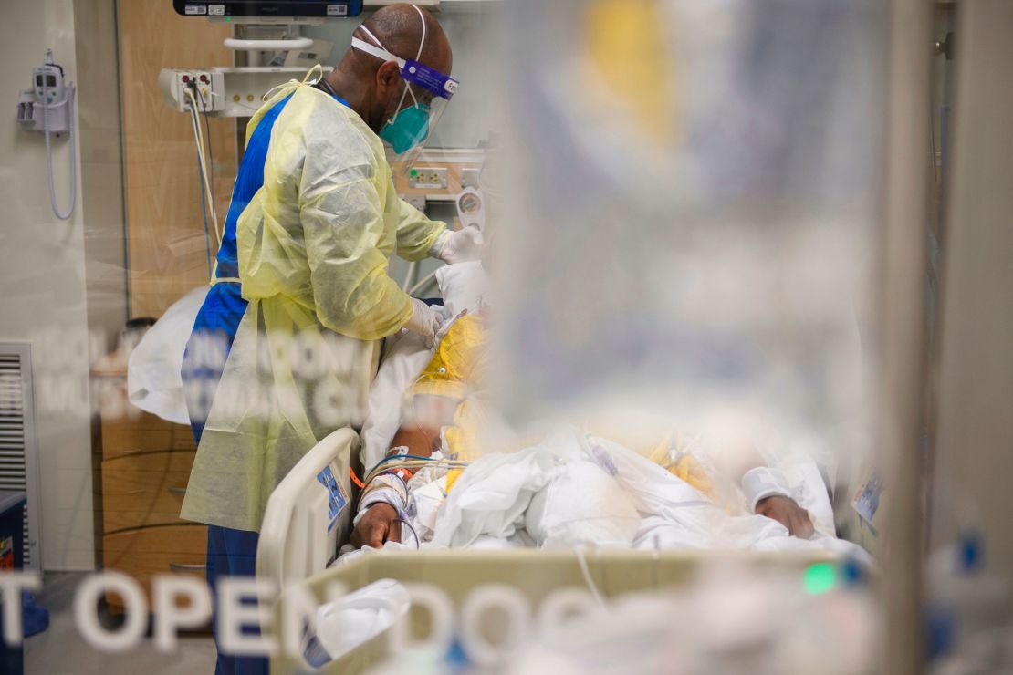 Nurses wearing PPE attend to patients in a California ICU. The parallels with the AIDS era are clear.