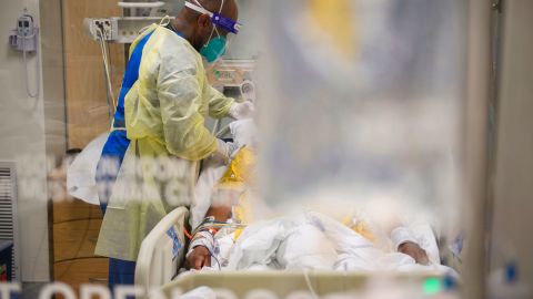 Nurses wearing PPE attend to patients in a California ICU. The parallels with the AIDS era are clear.