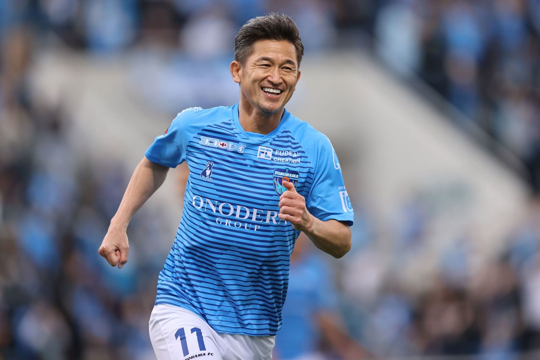 Miura smiles while on the pitch for Yokohama FC against Vissel Kobe