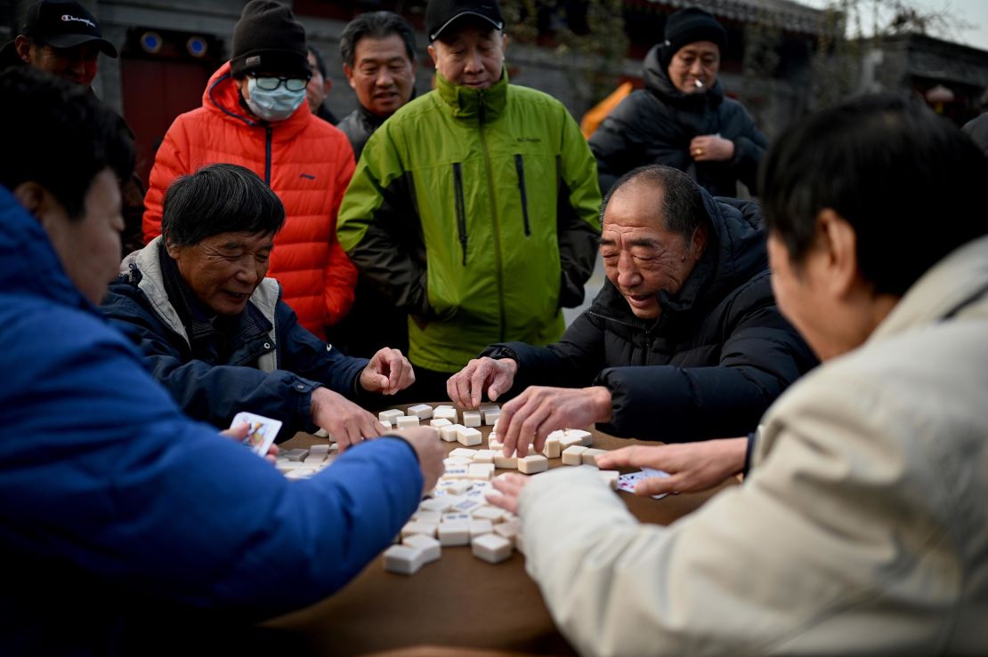 People play mahjong along a street in Beijing, China, on December 1, 2020.