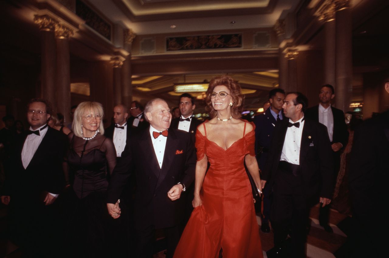 Adelson holds the hand of his wife, Miriam, at the 1999 opening of The Venetian hotel and casino in Las Vegas. Joining them was actress Sophia Loren.