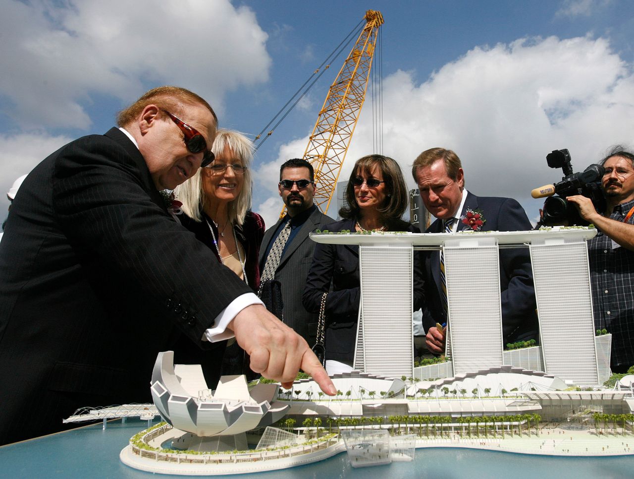 Adelson points at a model of the Marina Bay Sands casino during a groundbreaking ceremony in Singapore in 2007.