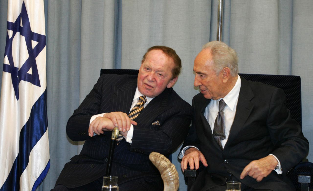 Adelson listens to Israeli President Shimon Peres during an official event at the president's residence in Jerusalem in 2007. Adelson owned Israel's largest daily newspaper by circulation. He also donated to the Holocaust remembrance center in Jerusalem and helped underwrite Birthright Israel, which pays for educational trips to Israel for young Jewish adults.