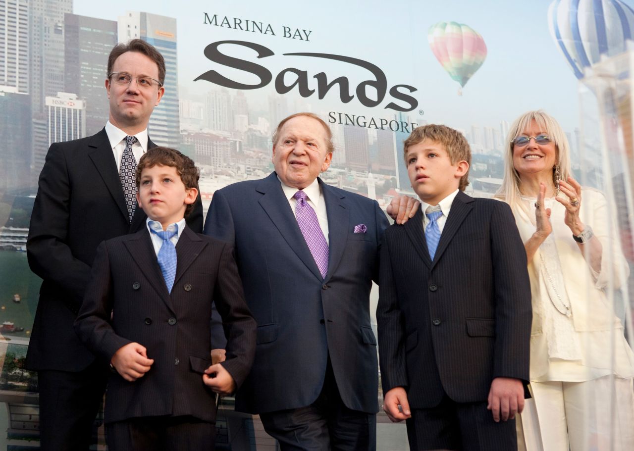 Adelson, his wife and their young sons attend a ceremony at the Marina Bay Sands in Singapore in 2009. At left is George Tanasijevich, general manager and vice president of Sands' Singapore development.