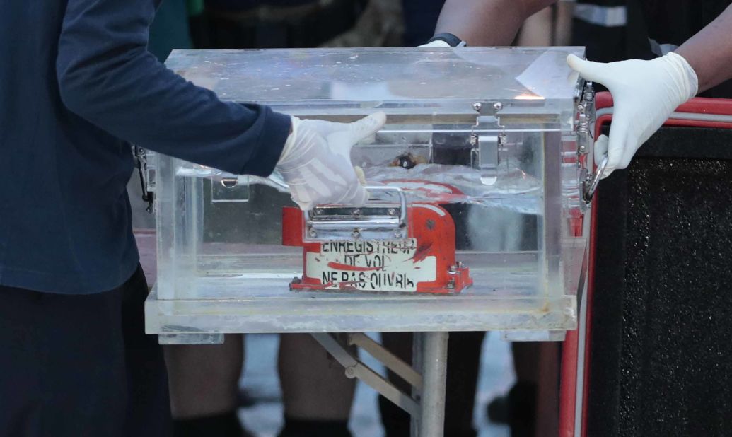Members of Indonesia's National Transportation Safety Committee carry a box containing the flight data recorder from Sriwijaya Air Flight 182 after the recorder was retrieved from the Java Sea on Tuesday, January 12.