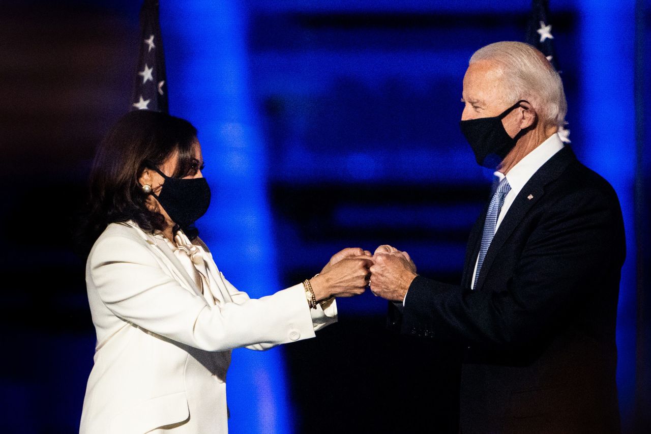 Biden and Harris greet each other on the stage where they delivered their victory speeches.