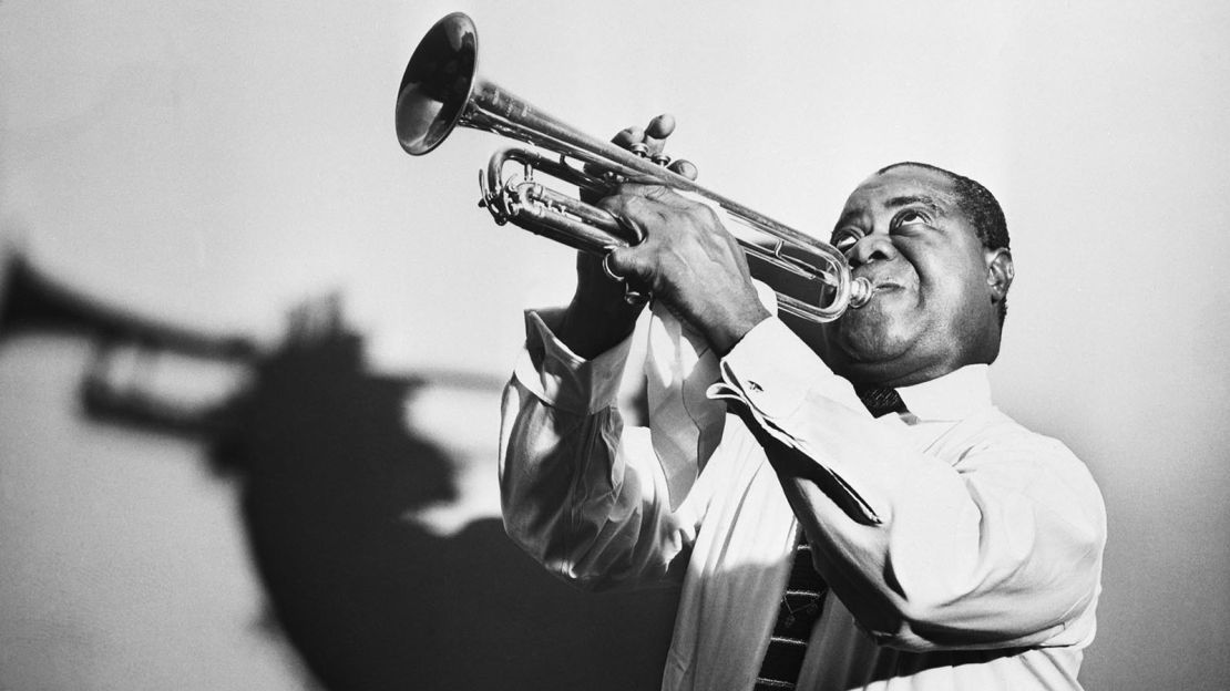 Louis Armstrong blowing his trumpet in a publicity photo from 1960.