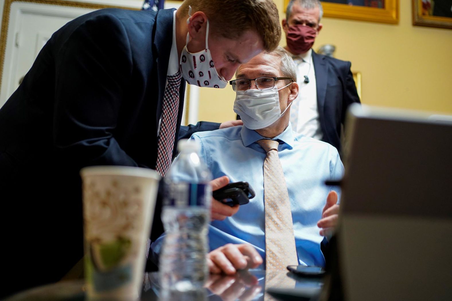 US Rep. Jim Jordan, a Republican from Ohio and a staunch Trump ally, speaks with an aide after a meeting of the House Rules Committee on January 12. The committee was meeting to debate the resolution calling on Vice President Pence to invoke the 25th Amendment.