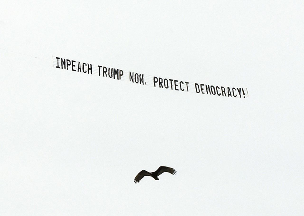 A banner flies over Orlando on January 7, calling for Trump's impeachment.