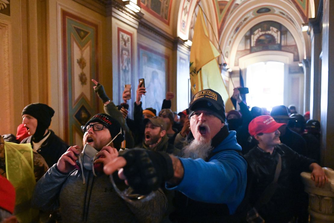A man wearing an Oath Keepers hat is among the mob inside the US Capitol on January 6 in Washington, DC. The Oath Keepers is a pro-Trump, far-right, anti-government group that tries to recruit members from active or retired military.