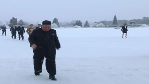 Kim Jong Un and his sister Kim Yo Jong (in the back right) are seen walking in the snow in footage aired by North Korean state media.