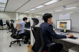 Workers at the office of the Korea Communications Standards Commission (KCSC) in Seoul on November 8, 2019, where staff are tasked with hunting down and removing internet sex videos posted without consent. 