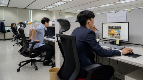 Workers at the office of the Korea Communications Standards Commission (KCSC) in Seoul on November 8, 2019, where staff are tasked with hunting down and removing internet sex videos posted without consent. 