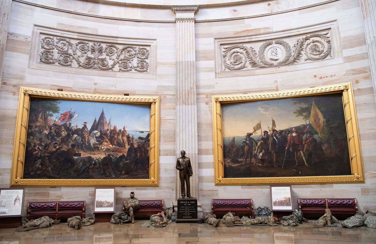Members of the National Guard rest in the Capitol Rotunda.