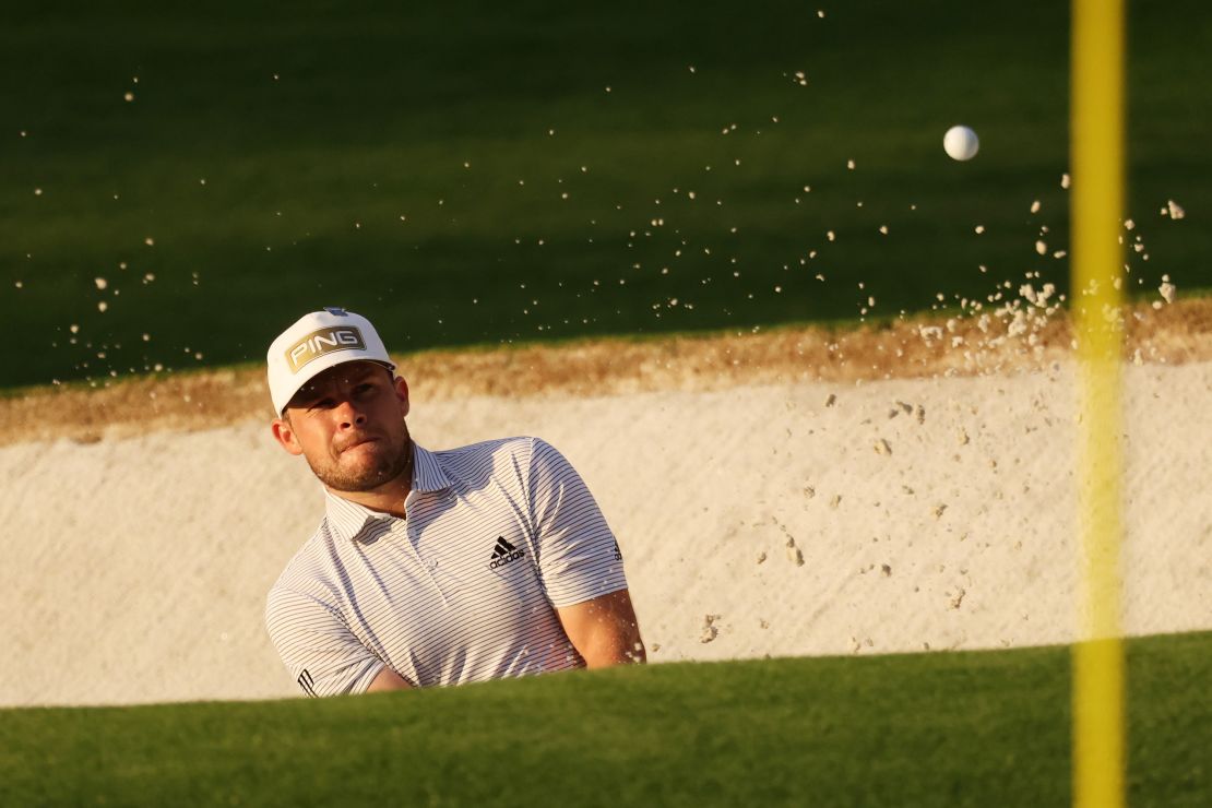 In the first round of the Masters at Augusta Hatton plays a shot out of a bunker. 