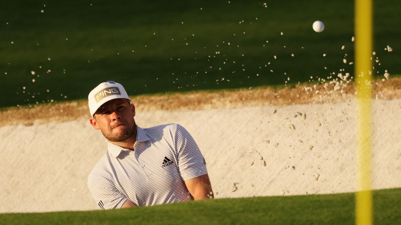 In the first round of the Masters at Augusta Hatton plays a shot out of a bunker.