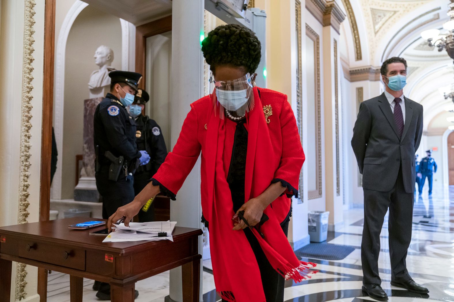 US Rep. Sheila Jackson Lee, a Democrat from Texas, gathers her papers before entering the House chamber on January 13. Members of Congress <a href="index.php?page=&url=https%3A%2F%2Fwww.cnn.com%2F2021%2F01%2F13%2Fpolitics%2Fhouse-floor-metal-detectors%2Findex.html" target="_blank">had to walk through metal detectors</a> in the wake of the Capitol attack.