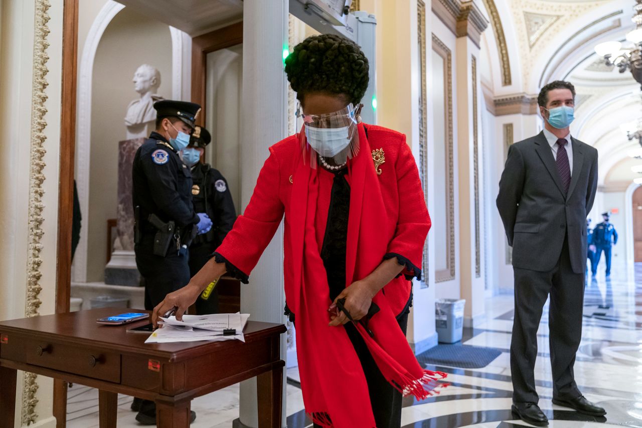 US Rep. Sheila Jackson Lee, a Democrat from Texas, gathers her papers before entering the House chamber on January 13. Members of Congress <a href="https://www.cnn.com/2021/01/13/politics/house-floor-metal-detectors/index.html" target="_blank">had to walk through metal detectors</a> in the wake of the Capitol attack.