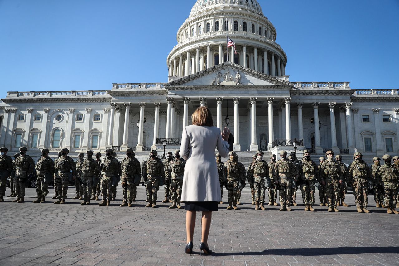 Pelosi stands in front of National Guard troops as she speaks outside the US Capitol on January 13.