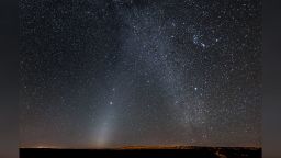 This photo shows a phenomenon known as zodiacal light. At lower left, a glowing patch extends to the upper right in the direction of Jupiter, the bright object left of center. Zodiacal light is caused by sunlight reflecting off tiny dust particles in the inner solar system—the disintegrated remains of comets and asteroids. Attempts to measure how dark space is using telescopes like Hubble have been thwarted by this ambient glow.

As a result, astronomers relied on NASA's distant New Horizons spacecraft to observe the sky free from zodiacal light. The faint background they measured is the equivalent of seeing a neighbor's refrigerator light from a mile away.

This very wide, multi-frame panorama was taken in October 2014 at Canyon de Chelly National Monument in northeast Arizona. The zodiacal light is at left, with the northern Milky Way to the right. The Orion constellation is at top right. Jupiter is the brighter object left of center, while a similarly bright object to the right (below Orion) is Sirius. M44 (the Praesepe Cluster) is just above Jupiter. On the horizon, a yellow glow marks the location of the nearby town of Chinle, Arizona.