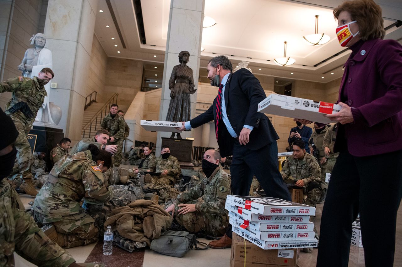 US Reps. Michael Waltz and Vicky Hartzler deliver pizza to members of the National Guard inside the Capitol Visitor Center.
