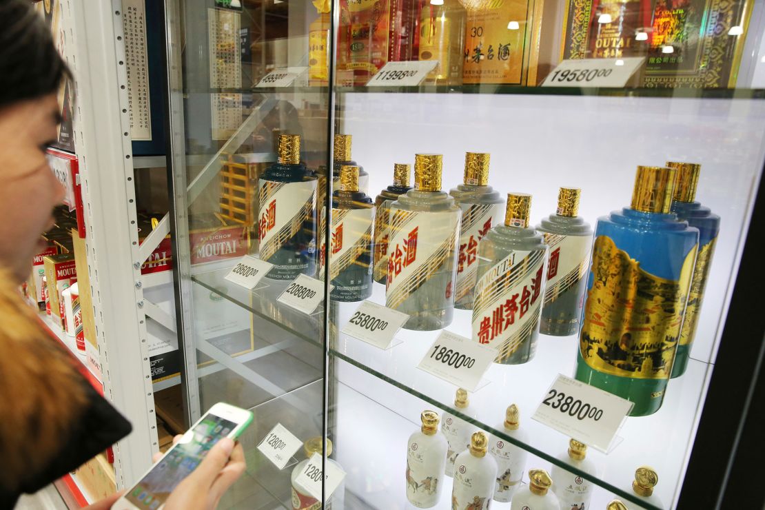 A customer shops for Kweichow Moutai at a supermarket in Nantong city, east China's Jiangsu province in December 2018.