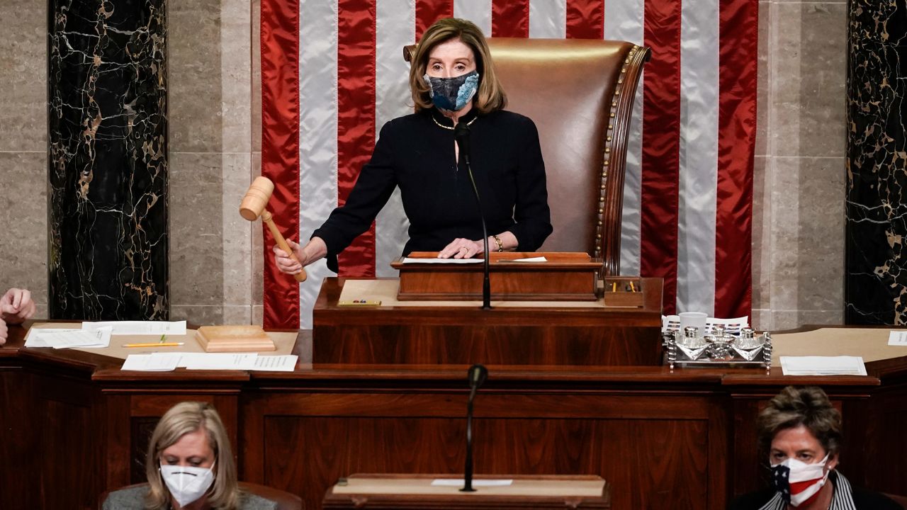 Pelosi bangs the gavel after the House voted to impeach Trump.