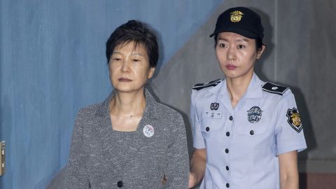 Park Geun-hye, former president of South Korea, is escorted by a prison officer as she arrives at the Seoul Central District Court in Seoul, South Korea on August 25, 2017. 