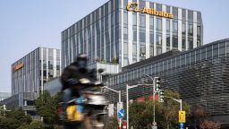 A motorist travels past an Alibaba Group Holding Ltd. office building in Shanghai, China, on Thursday, Dec. 24, 2020. China kicked off an investigation into alleged monopolistic practices at Alibaba and summoned affiliate Ant Group Co. to a high-level meeting over financial regulations, escalating scrutiny over the twin pillars of billionaire Jack Mas internet empire. Photographer: Qilai Shen/Bloomberg/Getty Images