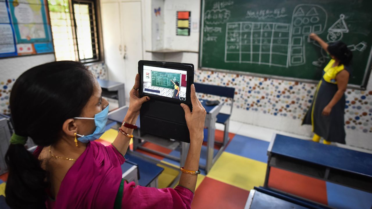 A teacher records her colleague conducting an online class during the coronavirus pandemic, September 22, 2020.