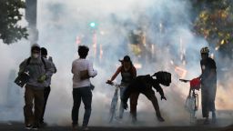 OAKLAND, CA - JUNE 1: Some protesters move away as police shoot tear gas and flash grenades to disperse the crowd on Broadway near the Oakland Police Department during the fourth day of protests over George Floyd's death by the Minneapolis police in Oakland, Calif., on Monday, June 1, 2020. (c)