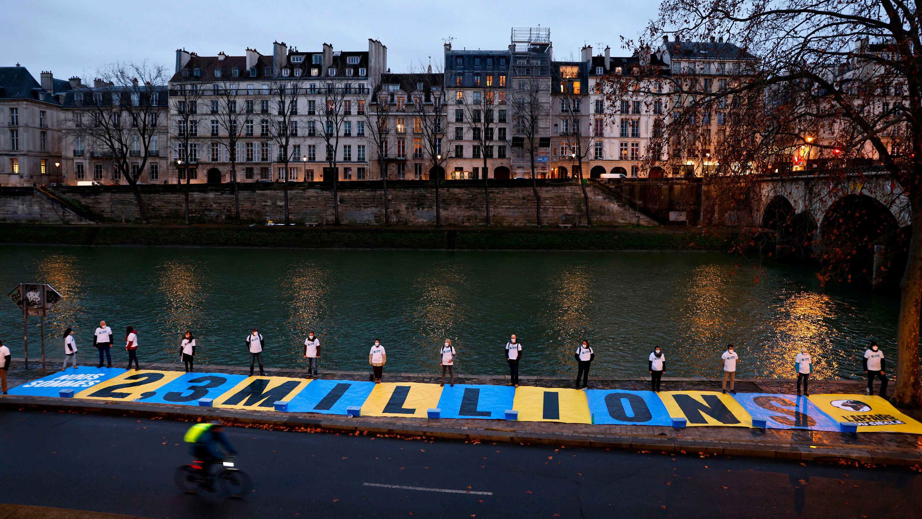 Activists unfurled a banner outside a Paris courthouse Thursday.