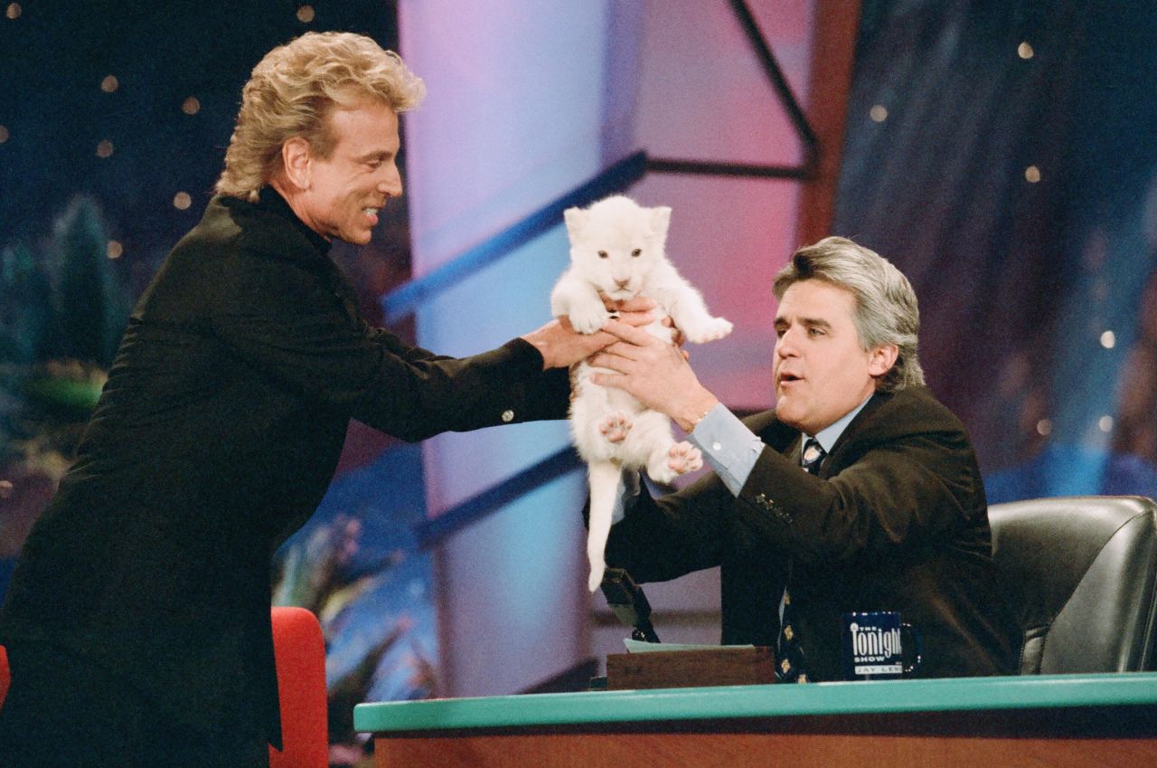 Fischbacher hands a cub to "Tonight Show" host Jay Leno in 1997.