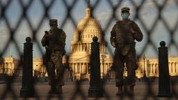 WASHINGTON, DC - JANUARY 14: Members of the New York National Guard stand guard along the fence that surrounds the U.S. Capitol the day after the House of Representatives voted to impeach President Donald Trump for the second time January 14, 2021 in Washington, DC. Thousands of National Guard troops have been activated to protect the nation's capital against threats surrounding President-elect Joe Biden's inauguration and to prevent a repeat of last week's deadly insurrection at the U.S. Capitol. (Photo by Chip Somodevilla/Getty Images)