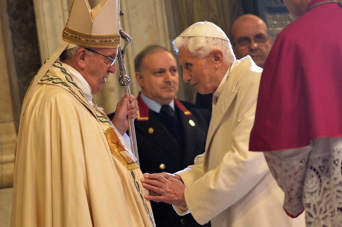 Pope Emeritus Benedict XVI speaks to Pope Francis at a ceremony at the Vatican in 2015. 