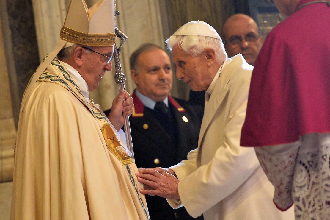 Pope Emeritus Benedict XVI speaks to Pope Francis at a ceremony at the Vatican in 2015.