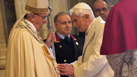 Pope Emeritus Benedict XVI speaks to Pope Francis at a ceremony at the Vatican in 2015. 